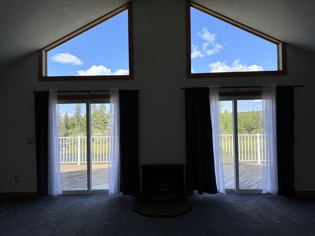 1537 Tecumseh Rd, Cheboygan, MI 49721 - carpeted living room with healthy amount of natural light and high vaulted ceiling