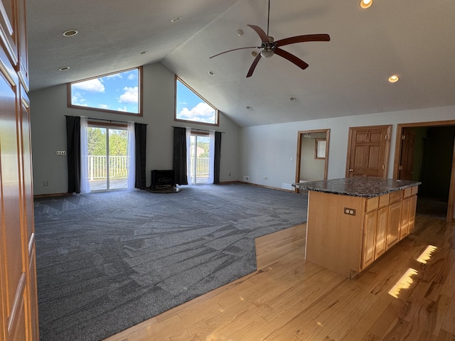 1537 Tecumseh Rd, Cheboygan, MI 49721 - unfurnished living room with high vaulted ceiling, baseboards, ceiling fan, light wood finished floors, and recessed lighting