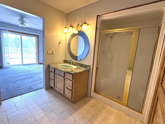 1537 Tecumseh Rd, Cheboygan, MI 49721 - full bath featuring vanity, a stall shower, a ceiling fan, and stone tile floors