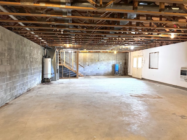 1537 Tecumseh Rd, Cheboygan, MI 49721 - unfinished basement with gas water heater, a water pressure tank, concrete block wall, and heating unit
