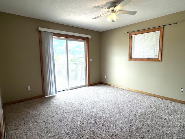1537 Tecumseh Rd, Cheboygan, MI 49721 - empty room with light colored carpet, a ceiling fan, baseboards, and a textured ceiling