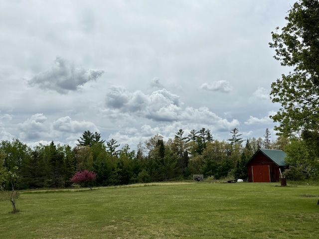 4650 Mckinley Rd, Mio, MI 48647 - view of green lawn with an outdoor structure and a garage