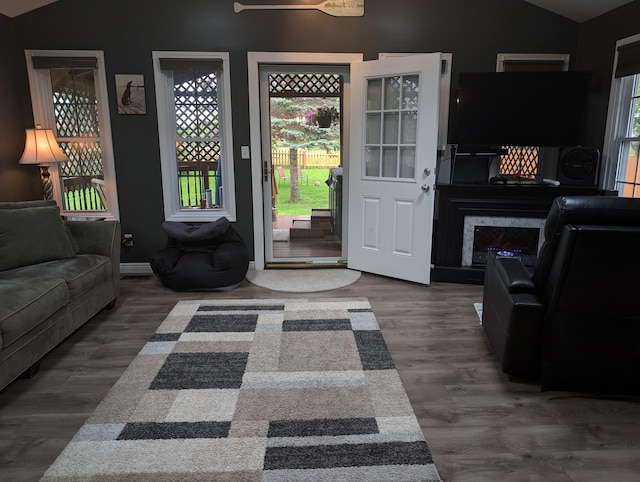 101 Island View Dr, Alpena, MI 49707 - living room featuring lofted ceiling, wood finished floors, ceiling fan, and baseboards