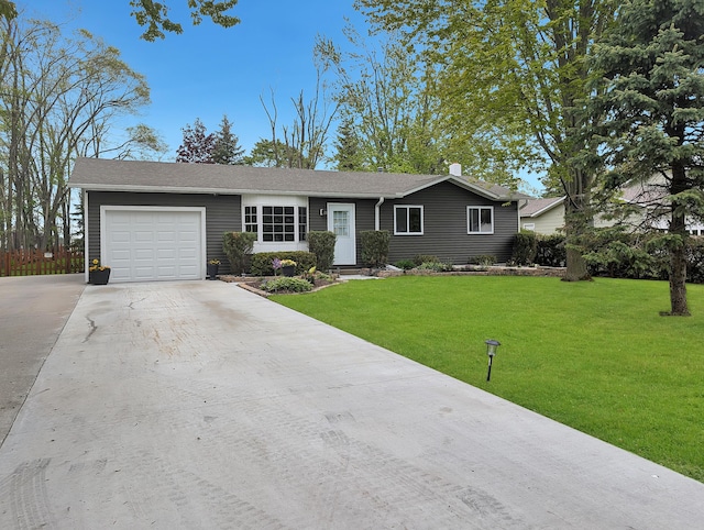 101 Island View Dr, Alpena, MI 49707 - ranch-style house with driveway, an attached garage, and a front yard