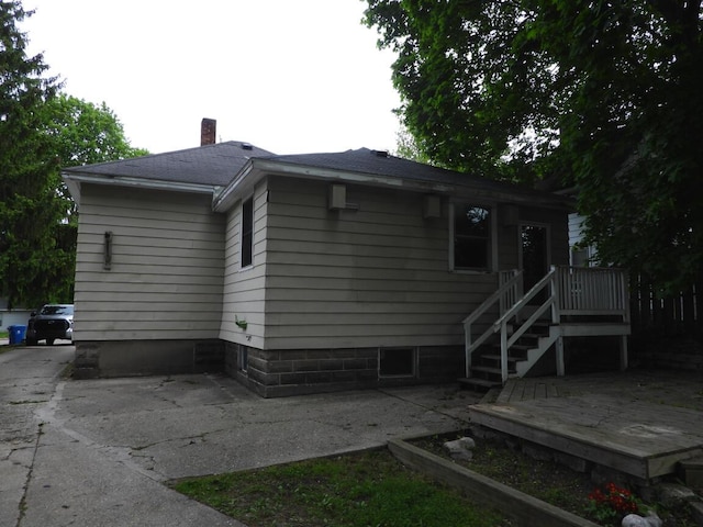 120 Copier St, Cadillac, MI 49601 - back of property with a chimney