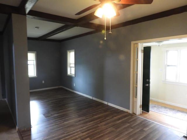 120 Copier St, Cadillac, MI 49601 - spare room featuring ceiling fan, dark wood finished floors, beamed ceiling, and baseboards