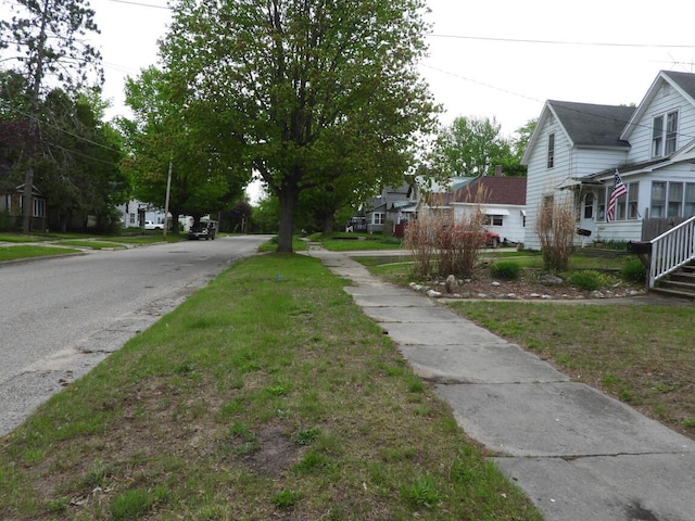 120 Copier St, Cadillac, MI 49601 - view of asphalt road with sidewalks and a residential view