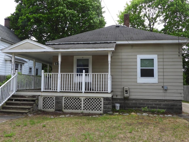 120 Copier St, Cadillac, MI 49601 - rear view of property with covered porch, a chimney, and roof with shingles