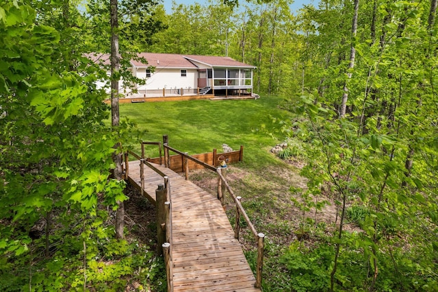 2510 Primrose Rd, Elmira, MI 49730 - back of house with a sunroom and a yard