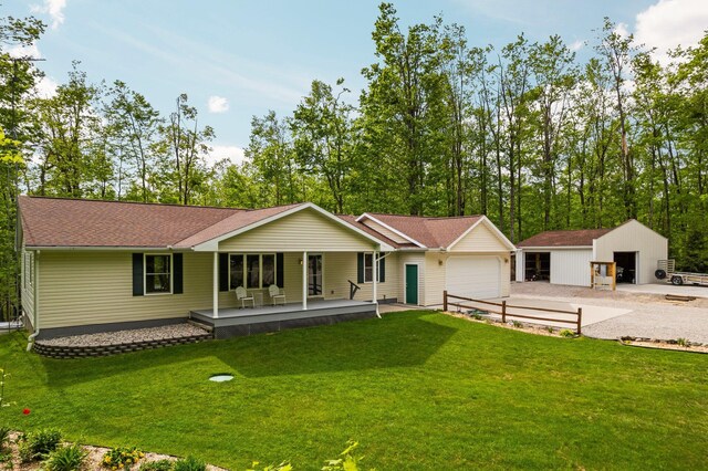 2510 Primrose Rd, Elmira, MI 49730 - view of front of house with a porch, a garage, a front yard, and driveway