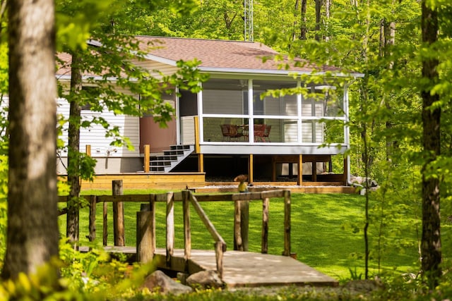 2510 Primrose Rd, Elmira, MI 49730 - rear view of house with a lawn, a sunroom, and roof with shingles