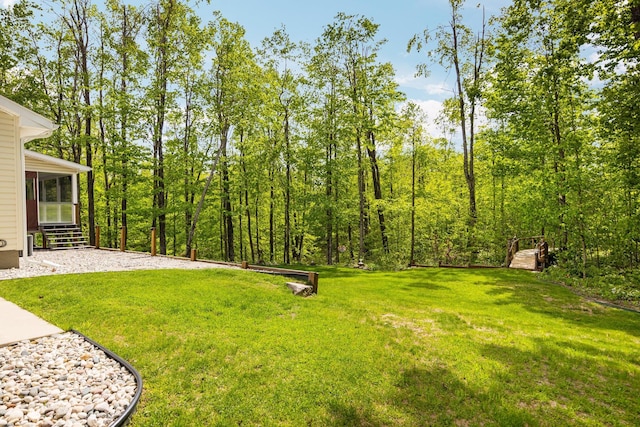 2510 Primrose Rd, Elmira, MI 49730 - view of green lawn with a sunroom