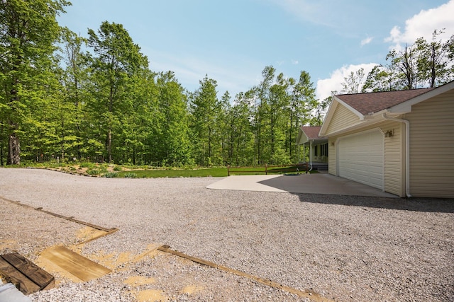2510 Primrose Rd, Elmira, MI 49730 - view of yard with driveway and an attached garage