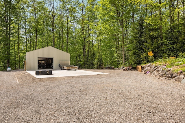 2510 Primrose Rd, Elmira, MI 49730 - view of yard with an outbuilding, a detached garage, and a wooded view