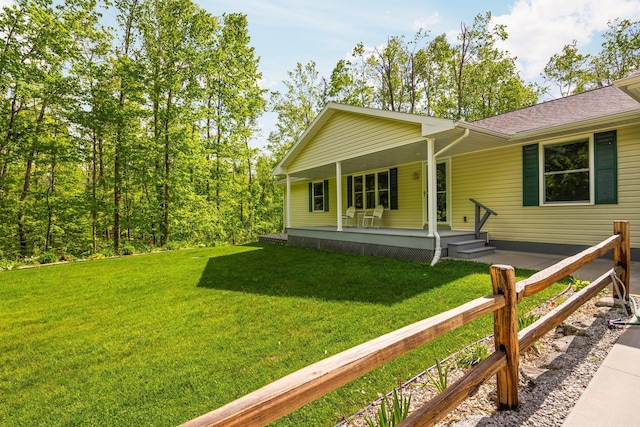 2510 Primrose Rd, Elmira, MI 49730 - view of front facade with a porch, a front yard, and a shingled roof