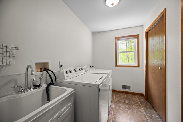 2510 Primrose Rd, Elmira, MI 49730 - washroom with washing machine and dryer, baseboards, and dark tile patterned flooring