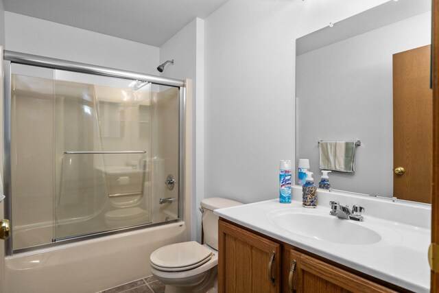 2510 Primrose Rd, Elmira, MI 49730 - bathroom featuring vanity, toilet, and enclosed tub / shower combo