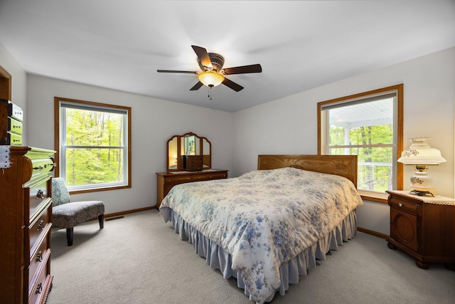 2510 Primrose Rd, Elmira, MI 49730 - bedroom with baseboards, light colored carpet, and a ceiling fan