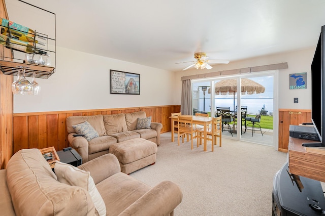 5616 W Houghton Lk, Houghton Lake, MI 48629 - living area with wooden walls, a wainscoted wall, a ceiling fan, and carpet floors