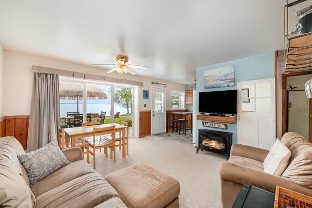 5616 W Houghton Lk, Houghton Lake, MI 48629 - living room with wainscoting, a ceiling fan, light colored carpet, and a glass covered fireplace