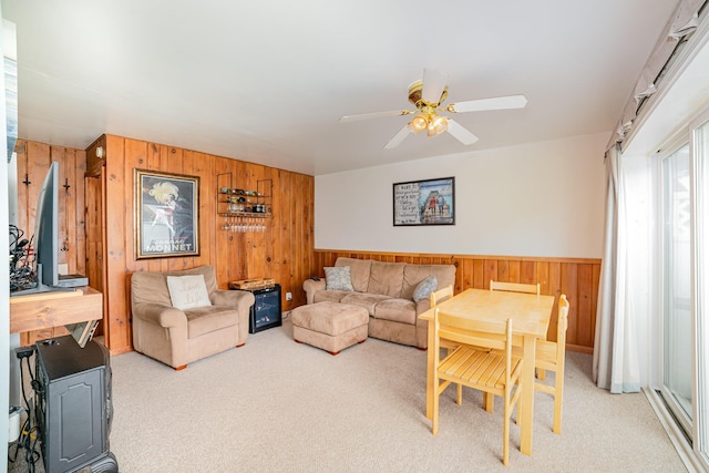 5616 W Houghton Lk, Houghton Lake, MI 48629 - living room featuring wooden walls, light carpet, and a ceiling fan