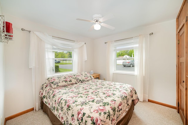 5616 W Houghton Lk, Houghton Lake, MI 48629 - bedroom featuring baseboards, light colored carpet, and ceiling fan