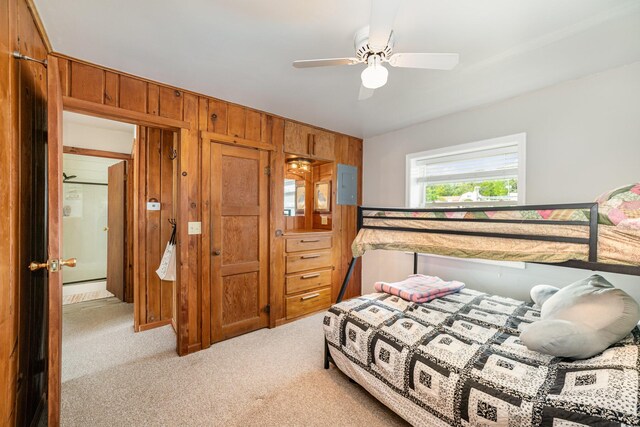 5616 W Houghton Lk, Houghton Lake, MI 48629 - bedroom with carpet, wood walls, and a ceiling fan