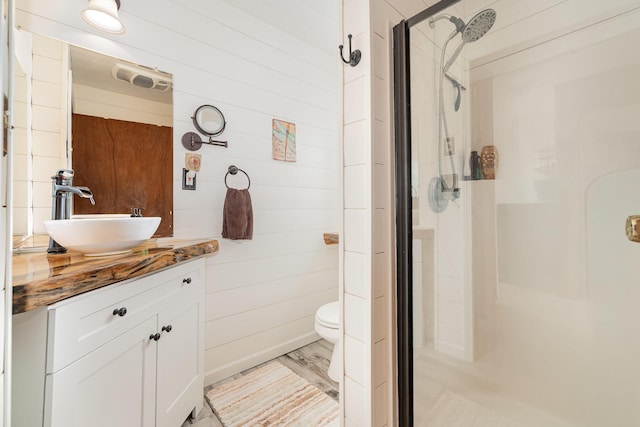 5616 W Houghton Lk, Houghton Lake, MI 48629 - bathroom with a stall shower, vanity, toilet, and wood walls