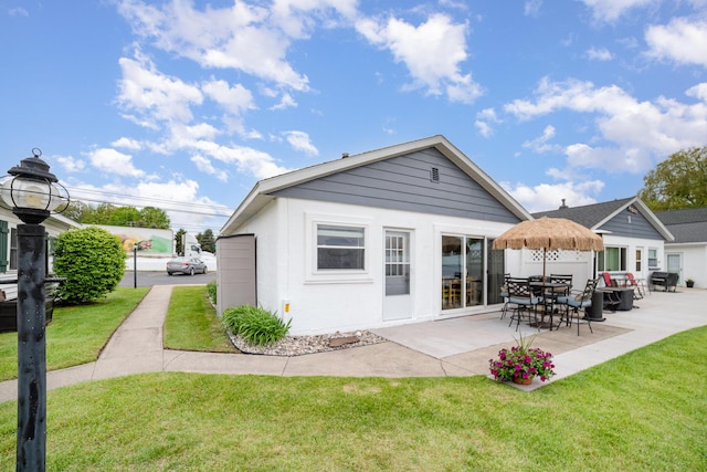 5616 W Houghton Lk, Houghton Lake, MI 48629 - back of property with a yard and a patio