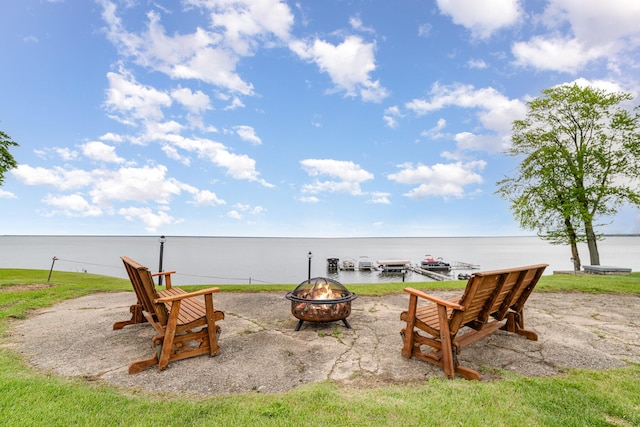 5616 W Houghton Lk, Houghton Lake, MI 48629 - view of patio with an outdoor fire pit and a water view