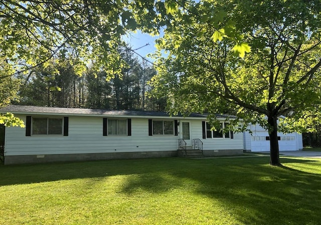 2056 Hobbs Dr, Alpena, MI 49707 - view of front of property with crawl space, a front lawn, an attached garage, and driveway