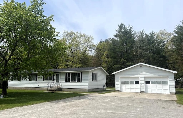 2056 Hobbs Dr, Alpena, MI 49707 - single story home featuring an outdoor structure, a detached garage, crawl space, and a front lawn