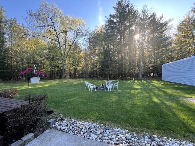 2056 Hobbs Dr, Alpena, MI 49707 - view of grassy yard featuring a fire pit