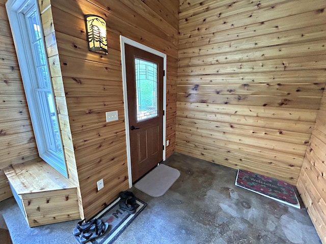 N1746 Smith Rd, Saint Ignace, MI 49781 - foyer entrance featuring concrete floors and wooden walls