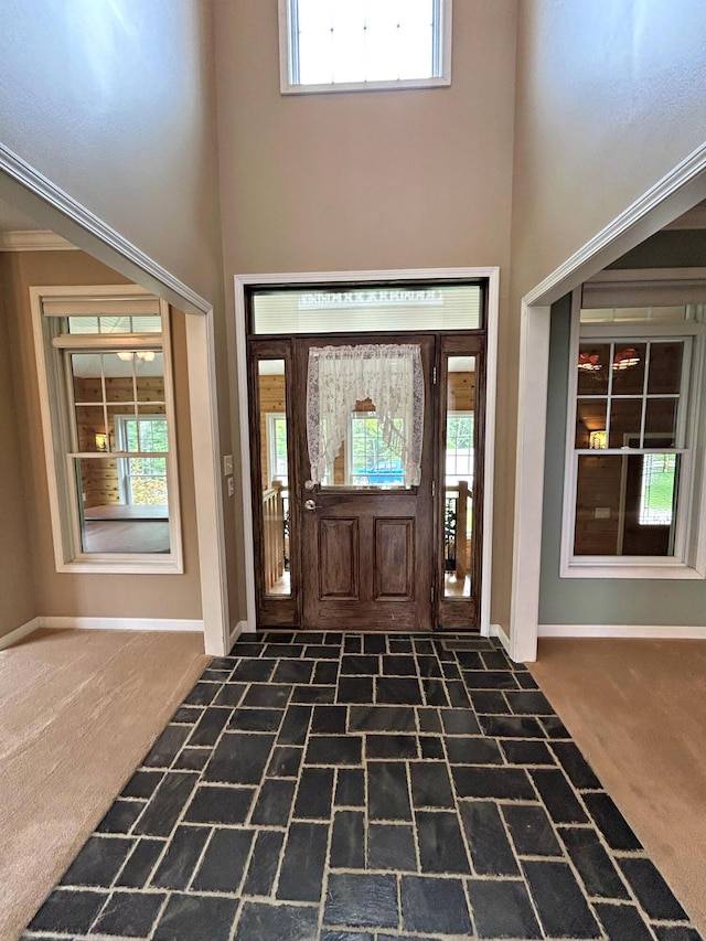 N1746 Smith Rd, Saint Ignace, MI 49781 - carpeted entrance foyer featuring a high ceiling