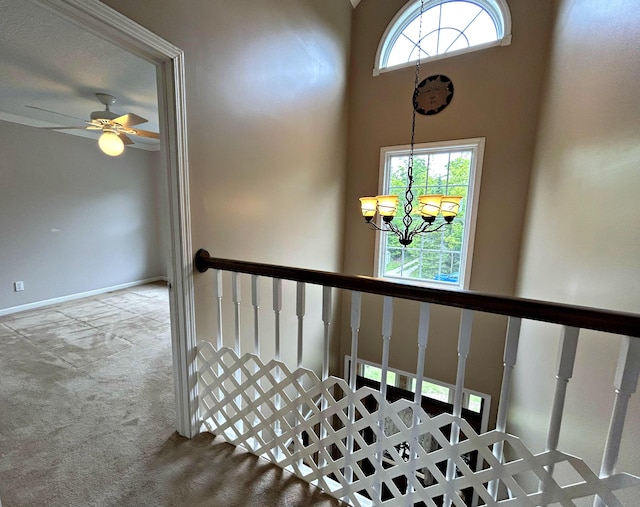 N1746 Smith Rd, Saint Ignace, MI 49781 - stairway with a chandelier, carpet, and ceiling fan