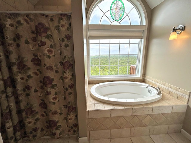N1746 Smith Rd, Saint Ignace, MI 49781 - bathroom featuring a garden tub, a shower with curtain, and tile patterned floors