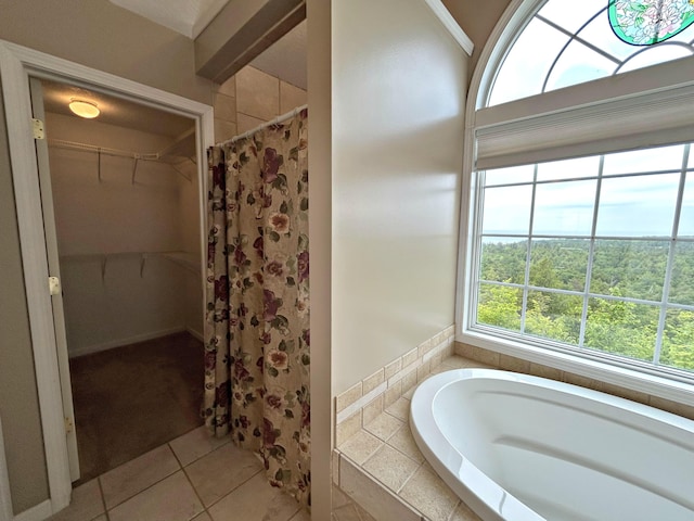 N1746 Smith Rd, Saint Ignace, MI 49781 - bathroom with a bath, a walk in closet, a shower with curtain, and tile patterned flooring
