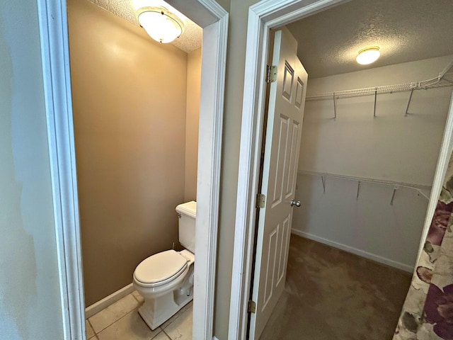 N1746 Smith Rd, Saint Ignace, MI 49781 - bathroom featuring a textured ceiling and a walk in closet