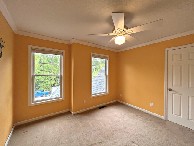 N1746 Smith Rd, Saint Ignace, MI 49781 - unfurnished room with crown molding, light carpet, ceiling fan, and a textured ceiling