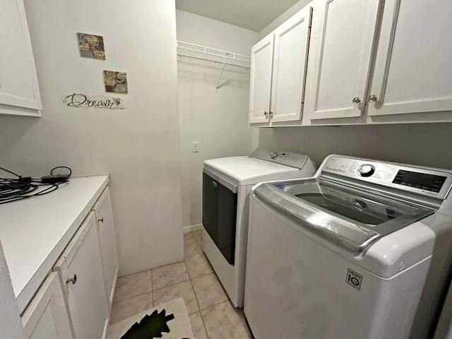 N1746 Smith Rd, Saint Ignace, MI 49781 - washroom with washer and dryer, cabinet space, and light tile patterned floors