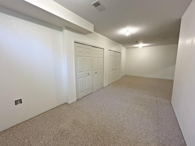 N1746 Smith Rd, Saint Ignace, MI 49781 - basement featuring carpet and a textured ceiling
