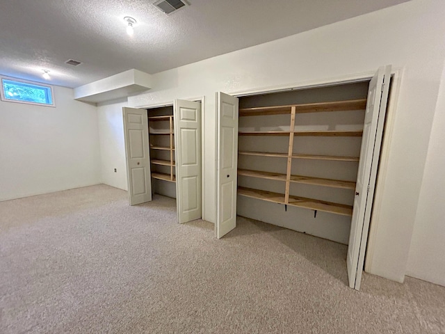 N1746 Smith Rd, Saint Ignace, MI 49781 - below grade area with carpet flooring and a textured ceiling