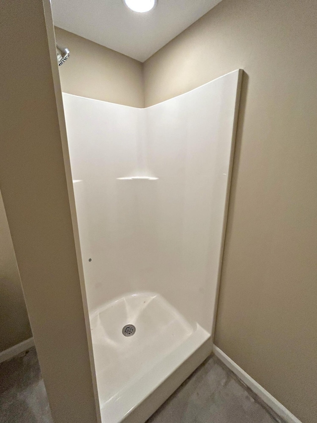 N1746 Smith Rd, Saint Ignace, MI 49781 - bathroom with a shower stall and baseboards