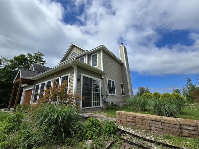 N1746 Smith Rd, Saint Ignace, MI 49781 - view of side of home with a chimney