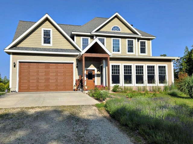 N1746 Smith Rd, Saint Ignace, MI 49781 - craftsman house featuring driveway and an attached garage