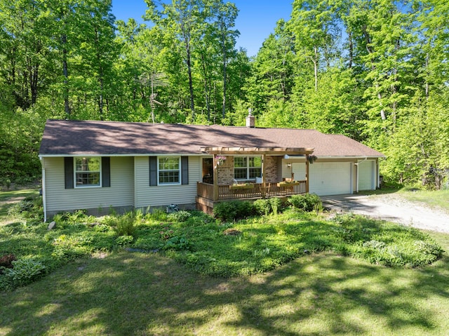 9707 Rogers Rd, Alanson, MI 49706 - single story home with driveway, an attached garage, a deck, a pergola, and a front yard