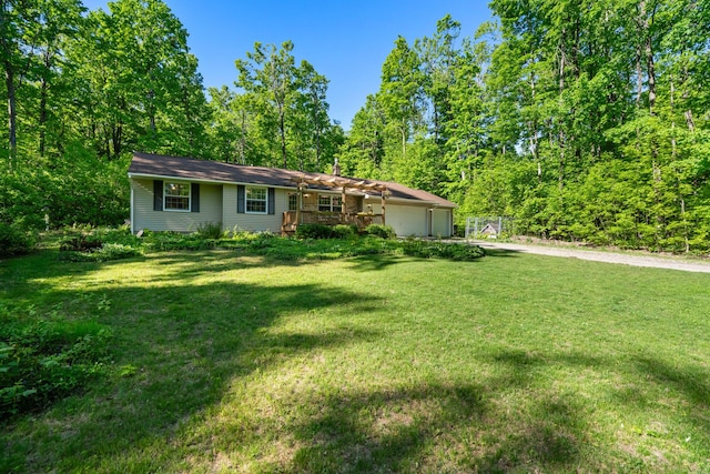 9707 Rogers Rd, Alanson, MI 49706 - ranch-style home featuring driveway, a front lawn, and an attached garage