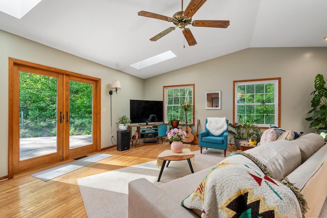 9707 Rogers Rd, Alanson, MI 49706 - living area featuring a skylight, plenty of natural light, light wood finished floors, and lofted ceiling