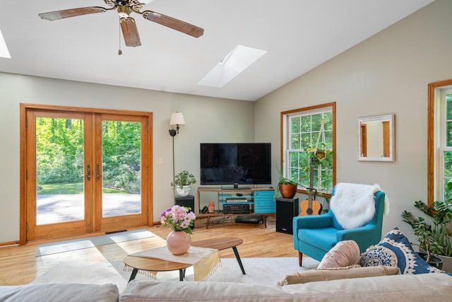 9707 Rogers Rd, Alanson, MI 49706 - living area with a skylight, vaulted ceiling, wood finished floors, french doors, and ceiling fan